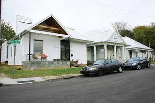 They purchased a historic duplex and bracketed it with two new houses, similar in form to the originals but wholly modern.