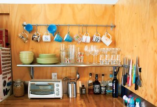 The kitchen countertops are made from affordable laminated oak intended to line the beds of tractor-trailers, which the couple coated with Salad Bowl Finish to create a food-safe surface.