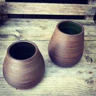 These rounder vases are from the UPO series. They can either sit on their own or hang suspended from a leather cord.