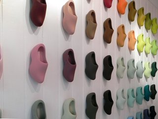 Colour Makes People Happy - Photo 1 of 5 - All 60 of Simon’s Siecle paint colors are displayed on clogs that cover the entire left hand wall of the shop in a rather striking display. Displaying them on a 3D shape instead of a flat card allows customers to see the colors in different degrees of light.