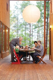The large wraparound porch links the two main houses and two guest cabins, and is the site of many impromptu shared meals.