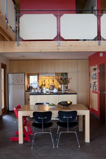 McMinn and Janzen's kitchen opens onto a double-height living and dining area.
