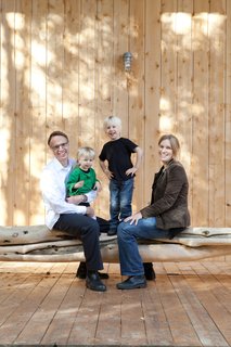 In addition to spaces for dining and napping, the porch shelters a kayak and this hanging bench-cum-balance beam made of salvaged tree trunks.