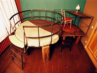 Although you can’t be over six feet tall to stay in this room, it is the most traditionally appealing. The bed and desk are built on top of a rustic "table," but otherwise everything is right side up and won’t trigger a panic attack.<br><br>For more information about the hotel, visit <br><br>propeller-island.de.