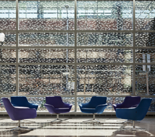 Finch etched and baked fritted brushtrokes into the glass walls and windows which don't obstruct the views from the interior out. By night, the building resembles, according to the artist, either a glowing lantern or a snow globe.