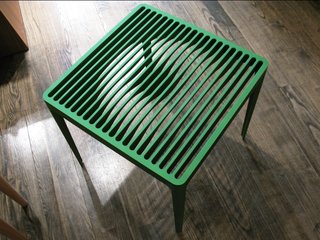 The experimentation and technical capabilities of Neal Feay’s factory inspired the designers. "When I got to the factory my brain was churning immediately," Ascalon says.<br><br>A nod to Neal Feay's claim of "Making Music from Metal," this side table - in green and grey - provides a playful visual surprise when one walks around it.