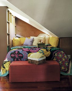 This top floor loft space in Atlanta has uneven ceilings and no walls, so Schuneman sectioned off a nook for her bed using a tall bookcase. Reprinted from The First Apartment Book by Kyle Schuneman. Copyright © 2012. Published by Clarkson Potter, a division of Random House, Inc.