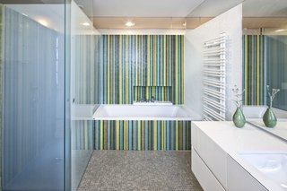 A Renovated Modernist Oasis in the French Riviera - Photo 6 of 9 - Glass elements not only allude to the ocean, but also lend a fresh look to some of the rooms. Here, Trend glass mosaic tiles brighten up the bathroom. Axor fixtures from Hansgrohe stand next to a minimalist radiator from Zehnder.