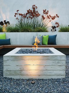A Craftsman-Style Bungalow is Turned Inside Out - Photo 3 of 6 - A cantilevered ipe bench hugs a custom board-formed concrete fire pit.
