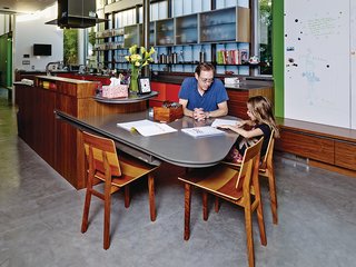 In the kitchen, the walls near the garden are painted green. The built-in table was designed by Chastain, and the Tone chairs are from De La Espada.