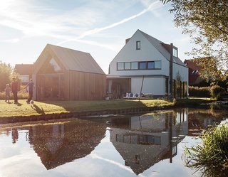 A Modern Take on the Pitched-Roof - Photo 1 of 12 - Located on a canal in a neighborhood outside central Amsterdam is the house Mark de Graaf and Sanne Wisman share with their three children. Architects Huib van Zeijl and Daniëlle Segers of Équipe based the pitched-roof house and shed on the local vernacular. "It’s a modern translation of a kid’s drawing of a typical Dutch house," says architect Huib van Zeijl.