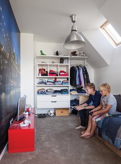 A Modern Take on the Pitched-Roof - Photo 10 of 12 - In a family's house in Amsterdam, a New York cityscape takes up one wall in Bram’s room, which has furnishings from Ikea and a bed from Goed Gemaakt.