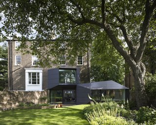 Victorian Home in London Gets a Modern Office Addition - Photo 1 of 7 - The roughly 5,000-square-foot Lens House renovation, which was finished in 2012 and just won a 2014 RIBA National Award, required six years, major remedial work on the roof and walls, approval from the planning committee, and even a sign-off from a horticulturalist to guarantee the backyard excavation didn't interfere with a walnut tree. "These things aren’t for people who are in a hurry," says architect Alison Brooks. The focus is the ten-sided trapezoidal office addition. "It wraps itself around the house with a completely different set of rules than the Victorian building," she says.