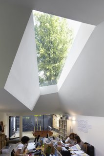 7 Incredible Home Offices of Designers and Architects - Photo 1 of 7 - The abstract geometry of the exterior allows for unique openings and this skylight, which provides natural light to the staff throughout the day. "One of my ambitions is to place openings, windows, and roof lights strategically, so you get a sense of the time of day and the weather," says Brooks.