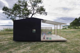 Elements like a concrete foundation can make a tiny home structurally stable and ready for variable weather, while a front porch creates an inviting entry.