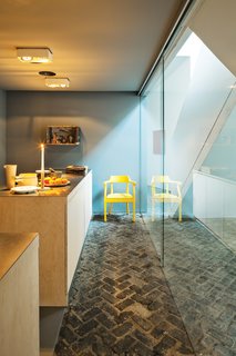 Wenes chose to keep the original brick floors to tie the older building to its past.