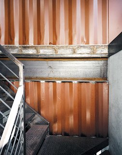 Embracing the industrial character of the corrugated steel material, he and Moseley applied the salvaged scraps as decorative siding for the hand-welded staircase.