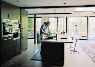 The custom kitchen boasts a suite of appliances by Miele and custom sliding doors and windows by Arcadia Architectural Series that open to views of the Delaware River, just across the street.
