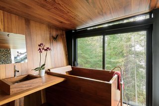 Inspired Indoor Teak Looks - Photo 4 of 14 - The Japanese-style bathroom, which is clad in teak, features a matching tub and sink by Bath in Wood.