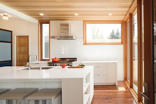 To maximize light, Dana opted for white surfaces, from the custom cabinetry to the Silestone countertops. "You can’t put a lemon or a Popsicle down on marble, so we got quartz, which is virtually indestructible," she says.