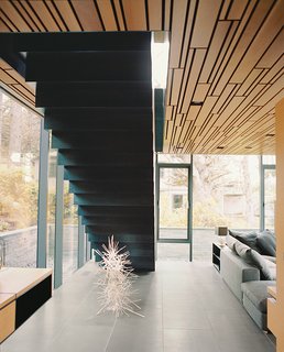 The brass sculpture on the gray basalt tile floor is by André Bloc.