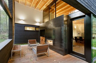 A fireplace can be used on the rear patio and in the living room, making it feel like one cohesive space. Ipe planks, the same wood that’s used in the front courtyard, cover the floor.