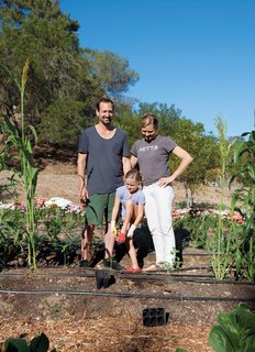 Gabbert and Avery pose with Ingrid in their "growing ground," planted and tended by local urban farmer Tara Kolla and a fleet of volunteers.