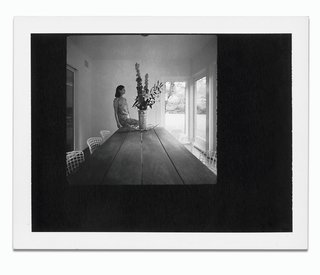 By the Book - Photo 2 of 2 - Architect Deborah Berke in the sun porch of her Long Island home, next to a teak table of her own design, surrounded by vintage Bertoia chairs.