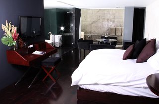 Hotel Demetria, Guadalajara - Photo 2 of 7 - This room managed to feel cozy despite the polished concrete, dark interiors, and glass walls.