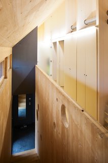 Passive Progressive - Photo 3 of 8 - Dividing Line<br><br>The home’s central "spine," which <br><br>Witzmann describes as "the back-<br><br>bone of the house at a load-bearing <br><br>and technical level," serves as the <br><br>structure’s organizing principle. It <br><br>groups the ventilation system and the <br><br>majority of the electrical networks <br><br>together and centralizes much of the <br><br>home’s storage. By siting the living <br><br>spaces on the south of the house <br><br>so that they take advantage of the <br><br>natural light, and placing the sanitary <br><br>and service rooms on the north, the <br><br>architects make the most of a smart <br><br>passive solar layout.