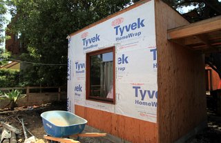 Dwell Home Venice: Part 14 - Photo 5 of 9 - Tyvek wrap and flashing seals the joint between a window and the wall of the front office. Caulking is placed on the interior. Eventually the entire home will be wrapped in Tyvek.