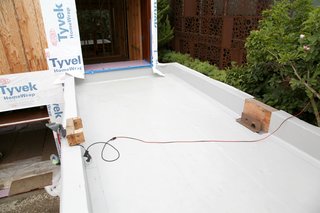 Dwell Home Venice: Part 14 - Photo 9 of 9 - The bridge from a guest bedroom to the media room will be an Intensive green roof. The width between the parapets will be filled with soil for planting. On the right a drainage scupper needs to be installed and then the PVC membrane will seal the area.