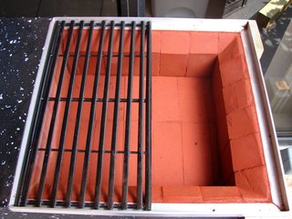 "I used regular mason bricks to cover the grill box and give the granite and outside surface heat protection. I calculated the bricks' thickness to accommodate an aluminum tray to hold the charcoal. The bricks installed on the three sides were cut to 45 degrees at the top to allow the heat to disperse more evenly. I used regular cement with red coloring to hold the bricks in place. For the grill, I selected a pair of rectangle grills to cover the square. I took their size into consideration before developing any other dimensions, so the grill would not have to be modified."