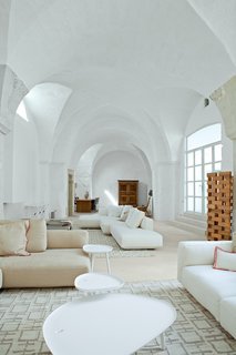 Modern Meets Ancient in a Renovated Italian Vacation Home - Photo 8 of 8 - At the far end of the living room, an old armoire—an inherited family heirloom—stands as a sober counterpoint to all the sleek Italian contemporary design in the five-bedroom house.