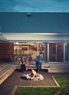 A Modern Farmhouse Recalls Old-Time Americana - Photo 3 of 10 - Though the fire pit was "kind of an after-thought," says Hannah, the family uses it year-round. "In the spring and fall, it warms you up on cool nights, and in the summer, it just adds ambience."