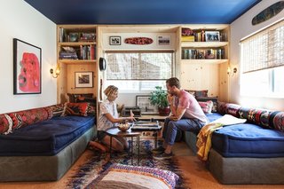 A Modern Beachside Trailer Home in Malibu - Photo 2 of 7 - Howard and Shumate in the living room, where Commune designer Steven Johanknecht introduced custom built-in daybeds with storage beneath. The carpet-fragment pillows are from Commune, as is the table, designed by Joshua Tree–based sculptor Alma Allen. The poster is by Mike Mills.