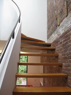City Modern Home Tours: Brooklyn - Photo 3 of 51 - Thick planks lead visitors up the staircase and compliment the wooden-beam details left exposed from the previous layout.