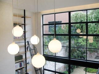 City Modern Home Tours: Brooklyn - Photo 5 of 51 - A view of the vertical library and garden beyond the 16-foot-tall wall of windows.