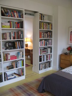 City Modern Home Tours: Brooklyn - Photo 11 of 51 - Bookshelf walls in a guest bedroom slide to reveal a small study.