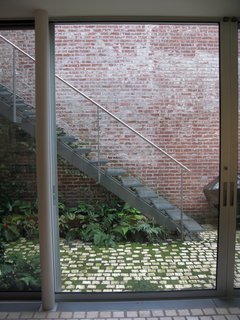 City Modern Home Tours: Brooklyn - Photo 21 of 51 - View of the garden from the lower level. Tile is used to create a visual transition from the indoor to outdoor environments.