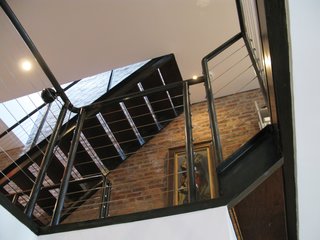 City Modern Home Tours: Brooklyn - Photo 34 of 51 - Parnass designed the home in layers rather than rooms, creating a fluid space filled with light from the large rear windows. Steel staircases and railings connect the spaces.
