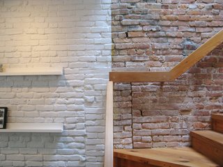 Even when painted with an even coat of white paint, the texture of an exposed brick wall still comes through.