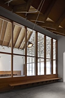 The café and gift shop are installations in and of themselves, capitalizing on the salvaged wood materials to create a more intimate environment within the museum.