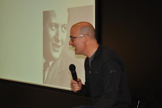 Nasir Kassamali: Design Lives - Photo 1 of 2 - Pardo talks onstage with Knoll founder, Hans G. Knoll, projected on the screen behind him.