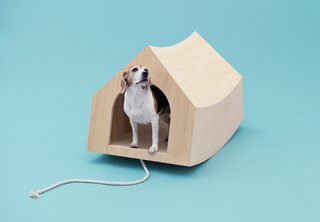 In the Doghouse - Photo 1 of 1 - Dutch architects MVRDV were assigned the beagle, a "curious and playful" breed the firm thought should have some power <br><br>of its own. An optional cord attached to the portable birch plywood structure means Fido can use the entire thing as a pull toy. <br><br>At rest, the pooch palace riffs on the traditional Snoopy-esque doghouse silhouette with its simple interior and gabled roof; <br><br>at play, it becomes a see-saw reminiscent of MVRDV’s own Balancing Barn.
