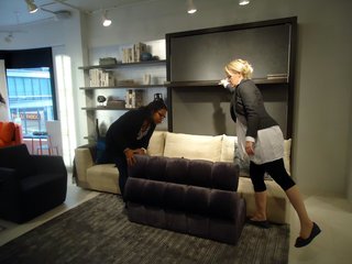 The ottoman in front of the sofa portion of the Atoll fits under the bed frame when folded down...