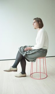 The 29-year-old designer, Catherine Aitken, on one of her stools for Fade.