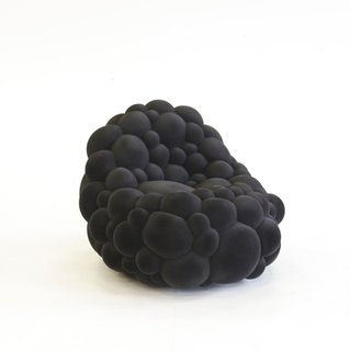 Low Organic Chair, 2012. Foam sphered around wood structure. By Maarten de Ceulaer.