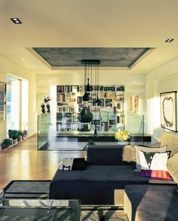 A Renovated Flat in Moshe Safdie's Habitat '67 - Photo 1 of 8 - "We wanted a space for entertaining groups, and also ourselves, that felt open—almost like a loft," says Peart of the couple’s mezzanine-level living room.