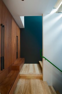 One of the most challenging aspects of the build was incorporating the residents' request for a diverse material palette. The flooring is ash and the cabinetry is Mahogany. Cash Barnes custom fabricated the steel railing as well as the bridge and insect screens.